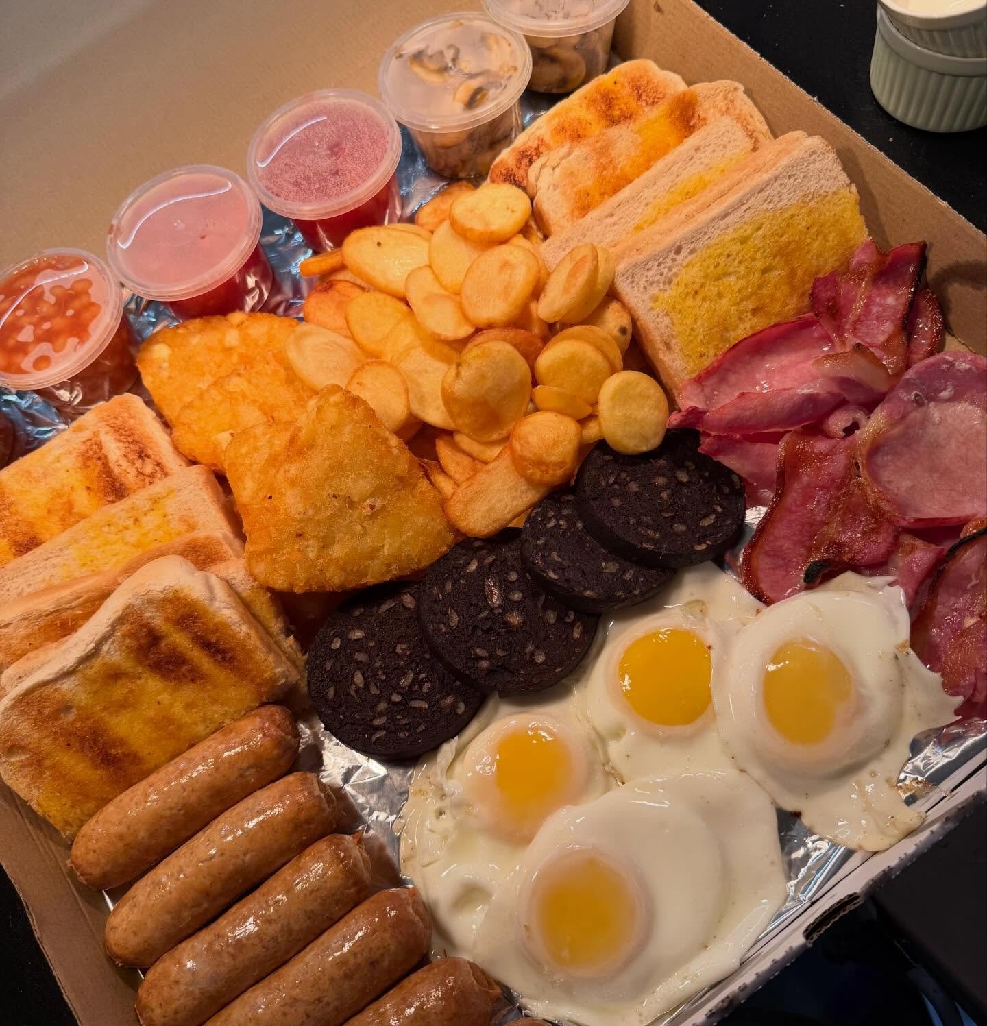 Sharing breakfast box with sausages, fried eggs, bacon, black pudding, hash browns and toast from The Oven Door Cafe, St Helens